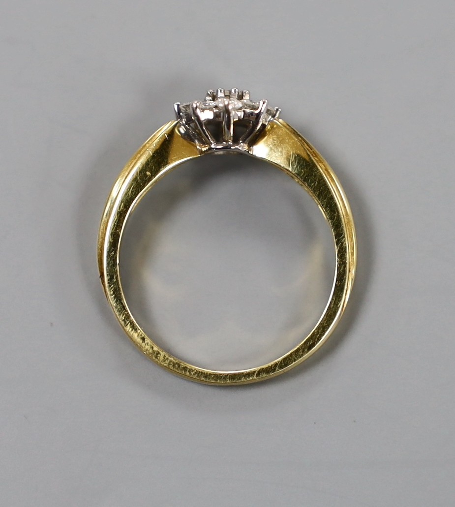 A modern 18ct gold and nine stone diamond cluster set flower head ring, size O/P, gross weight 4.4 grams